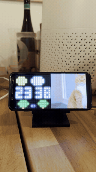 A small Pixel clock next to a cat slideshow.