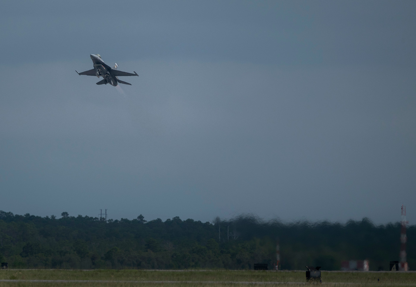 An F-16 modified with the Viper Experimentation and Next-generation Operations Model (VENOM) Autonomy Kit performs human-on-the-loop in-air testing of AI models, advancing flight autonomy within DARPA's Artificial Intelligence Reinforcements (AIR) program.