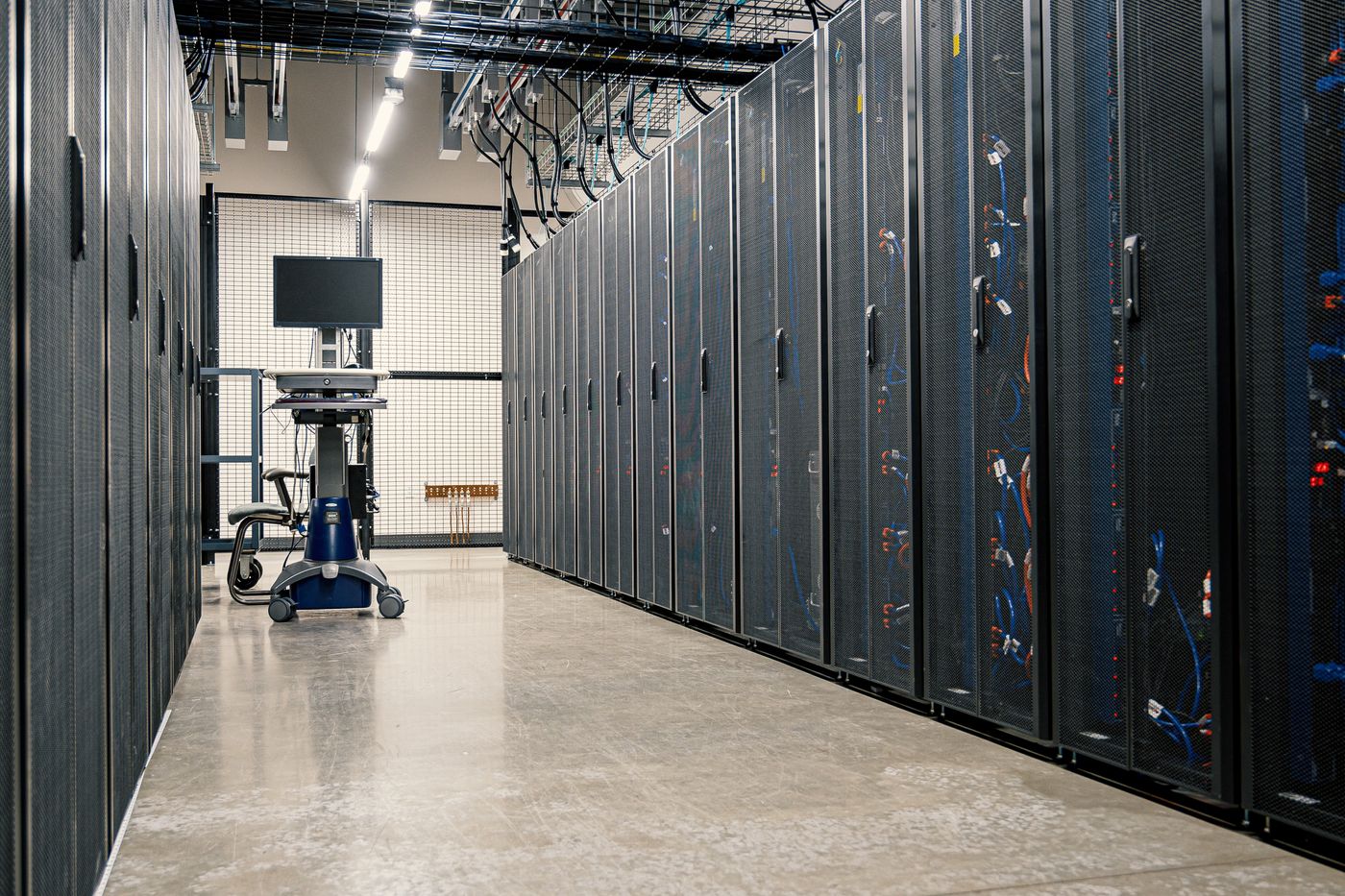 Data center server hall with rows of rack-mounted servers — the type of hyperscale infrastructure targeted by IRGC cruise missiles in Wave 24
