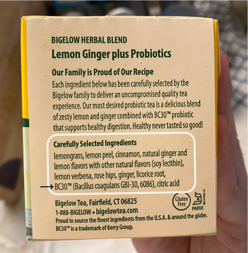 A hand holding a box of herbal tea AI-generated content may be incorrect.