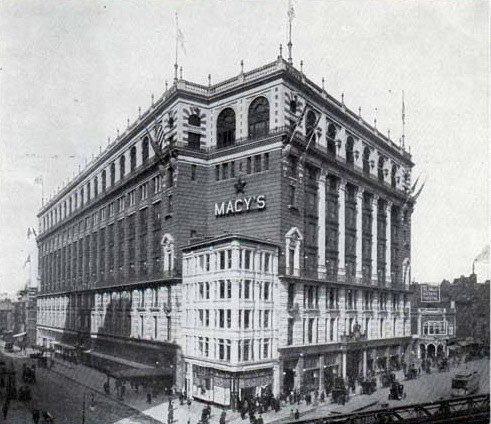Historic black and white photograph of the exterior of Macy's department store, showcasing its large facade and architectural details.