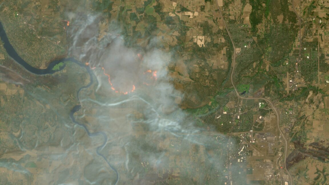 A satellite image taken by Europe's Sentinel 2 satellites shows a wildfire and smoke near Spokane, Washington.