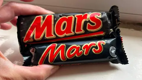 Victoria Gordon A Mars Bar from 1991 and a modern-day one held next to each other. The old Mars Bar is considerably bigger.