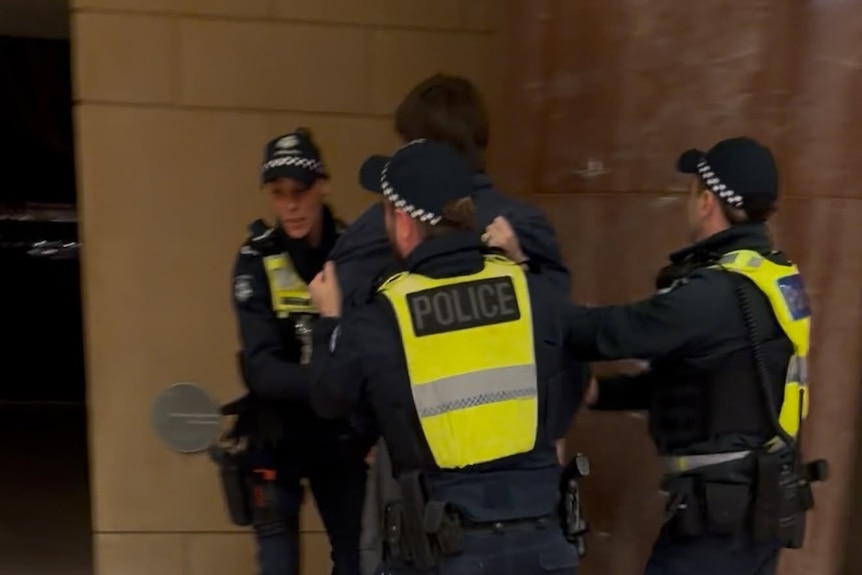Far-right agitator being confronted by three Victoria Police officers