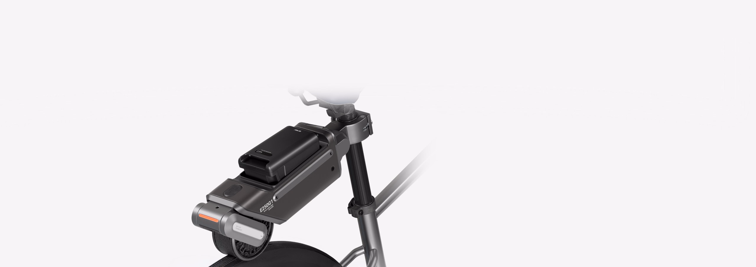 A sleek black battery pack with an integrated tail light is mounted on the rear rack of a bicycle.