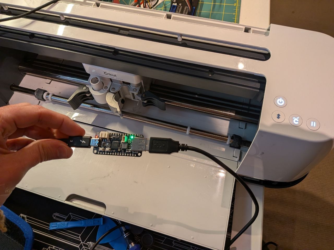 Circut Maker in background with a RP2040 microcontroller with two USB connections