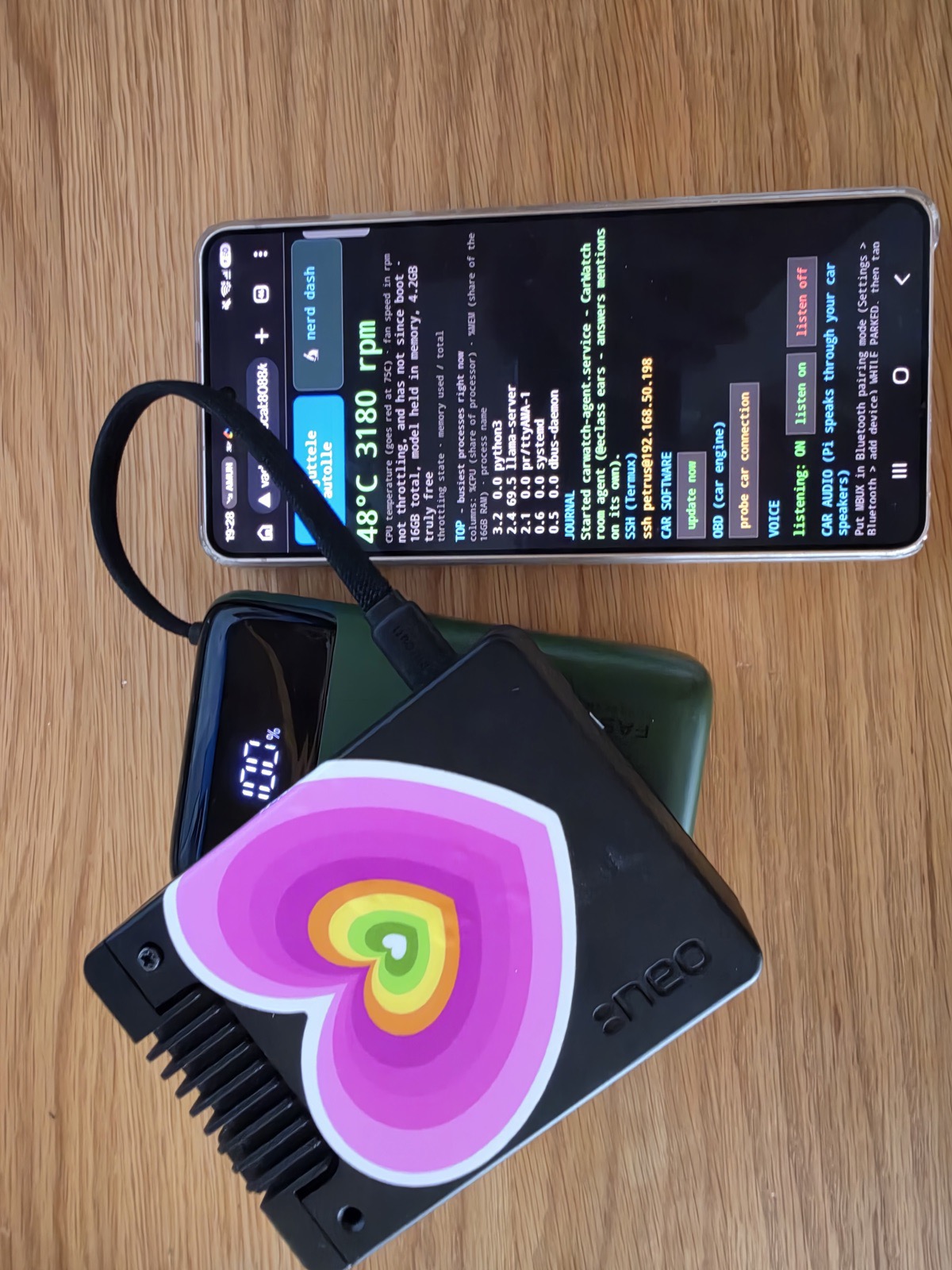 The CarWatch rig: Raspberry Pi in a heatsink case with a heart sticker, on a power bank