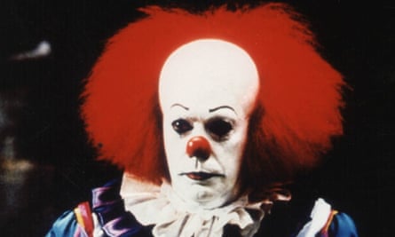 Curry in clown face makeup and red hair.