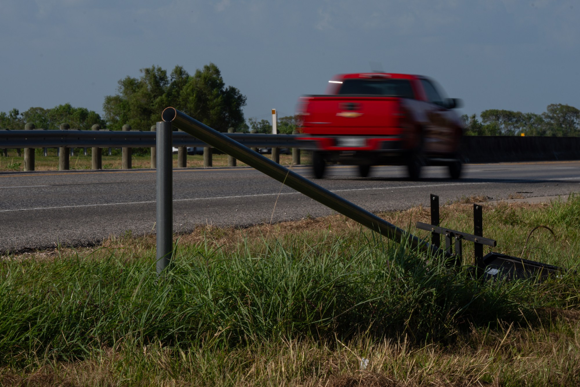 Drivers pass a destroyed Flock camera on the side of Texas 288 near Angleton on Sunday, Aug. 23, 2026.