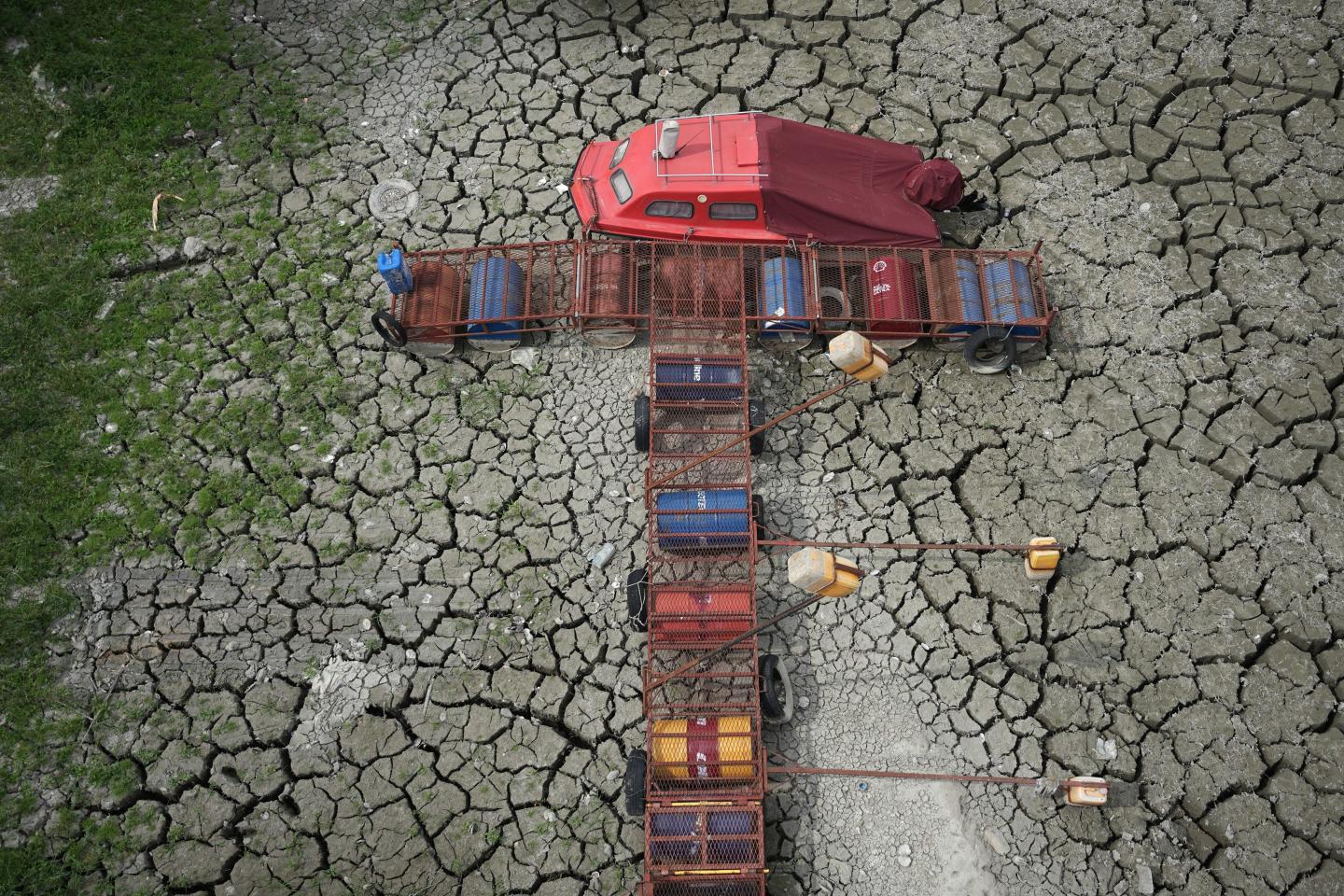 A boat sits on dry ground as water levels have dropped on the Danube River in Petrovaradin, Serbia, Tuesday, Aug. 25, 2026.