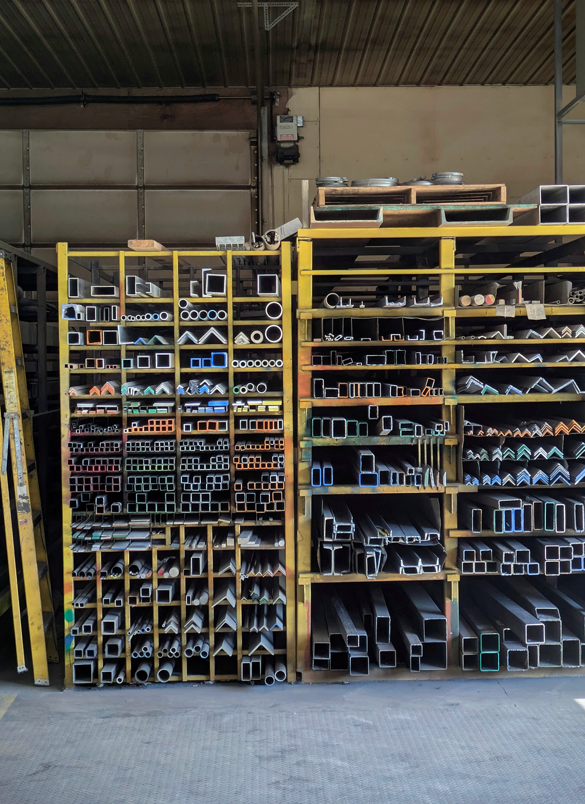 Aluminum and other metal stock on a rack at a metal supplier.