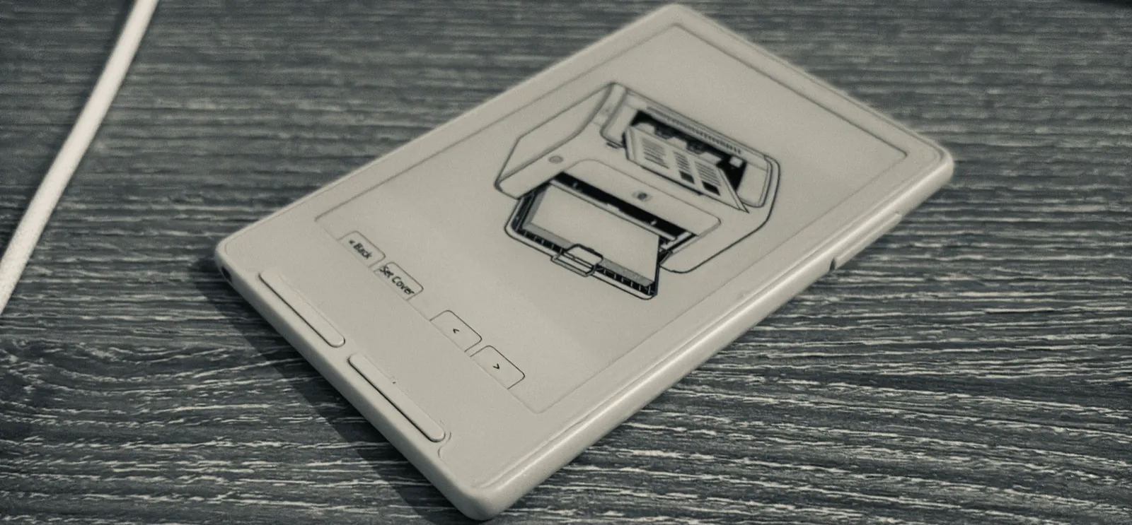 The Xteink X3 displaying a black-and-white drawing of a printer.