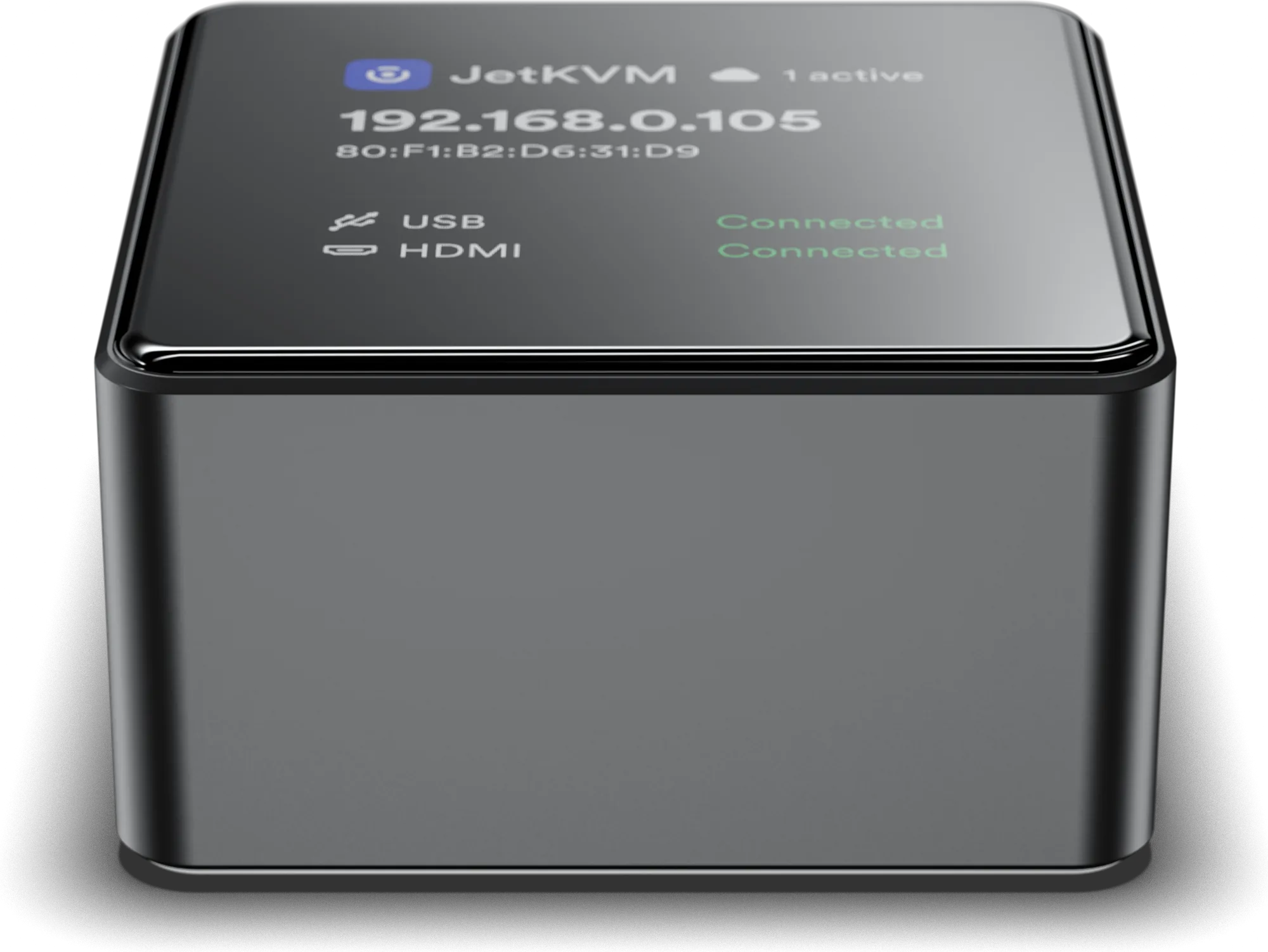 JetKVM Mini from the front, the display showing the IP address and USB and video status